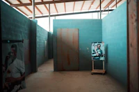 a blue room with a picture on the wall