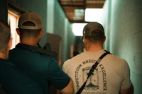 two men in hats standing in a hallway