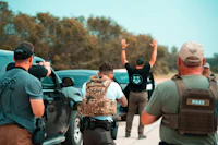 a group of people standing on the side of a road